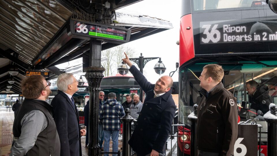 Pic 2 Buses Minister Points To £2 Fare Promo Hgt Bus Stn