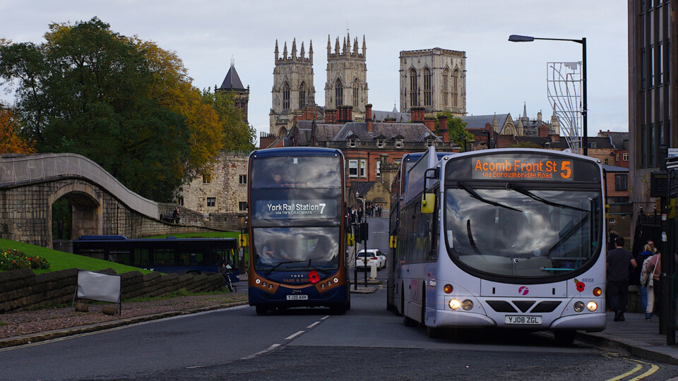 EV and diesel bus, Minster in background