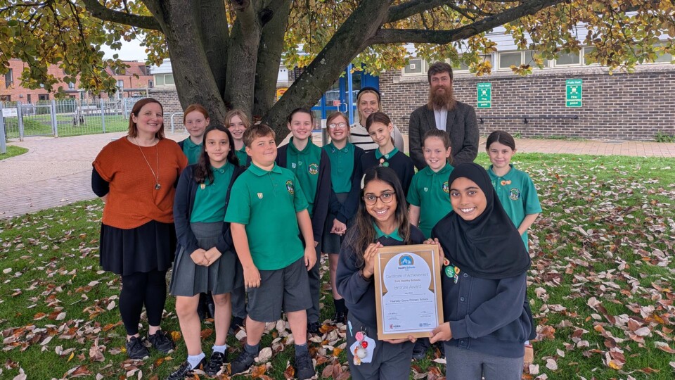 teacher, pupils from Yearsley Grove Primary School celebrate their award with Cllr Bob Web outside New Earswick Folk Hall.