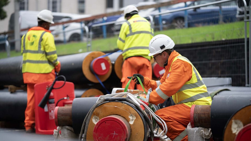Workmen with the super-insulated pipes used for Bradford Energy Network. Credit: University of Bradford.