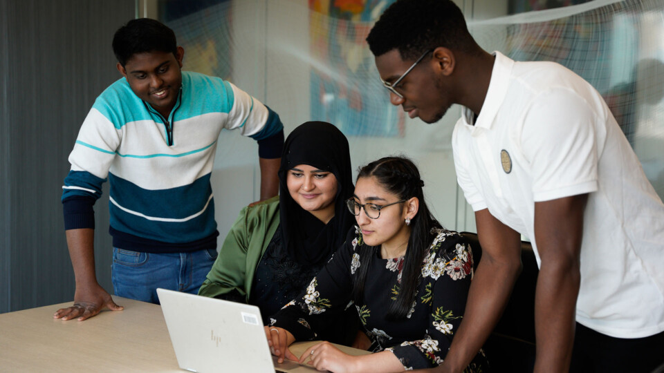 Group of young people working on laptop