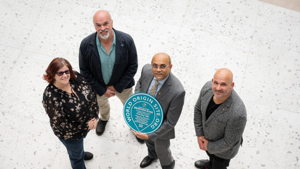 From left, Dr Kirsten Riches-Suman, Martin Wilkie, World Origin Site Founder, Professor Ajay L Mahajan, PSBRU Director holding the green plaque, and Davide Longo, Bradford City AFC General Manager. Images credit: Kiran Metha@KM Images  and University of Bradford